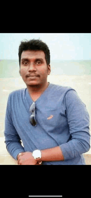 a man wearing a blue shirt with a puma logo