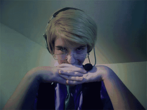 a person wearing a headset and glasses covering their mouth