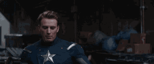 a man in a captain america costume holds a shield