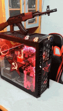 a rifle is sitting on top of a computer case