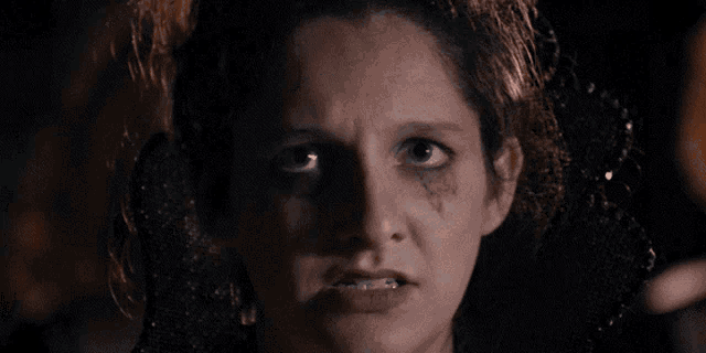 a close up of a woman 's face with a black eye