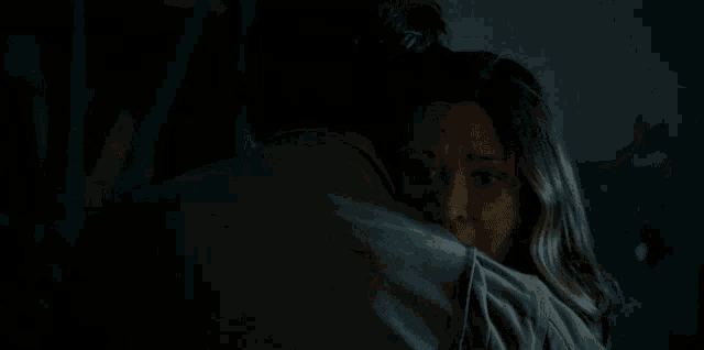 a man with a ring on his finger holds a woman 's head