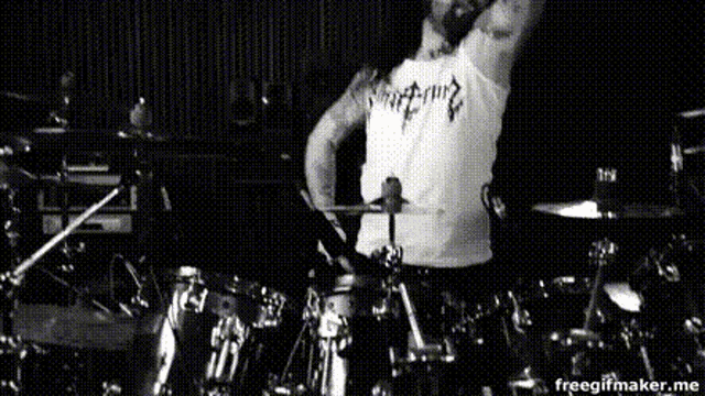 a black and white photo of a man playing drums with the words freegifmaker.me visible