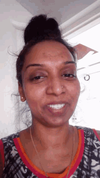 a close up of a woman 's face with the letter c visible in the corner
