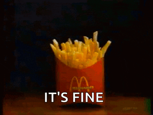 two boxes of mcdonald 's french fries are on a table