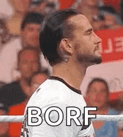 a man with a beard is standing in a boxing ring with the word borf written on his chest .