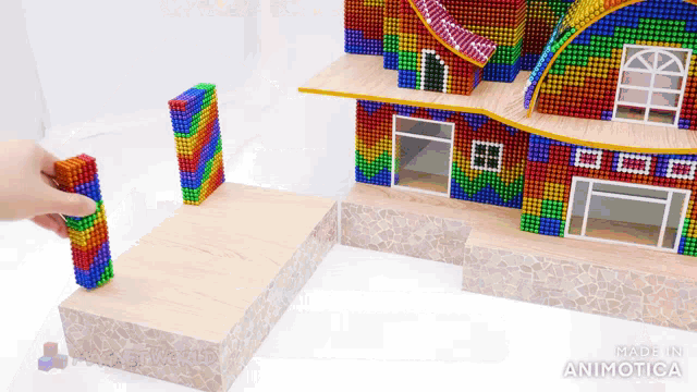 a house made out of magnets with the words made in animatica on the bottom right