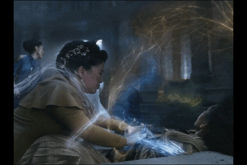 a woman with a crown on her head is surrounded by light