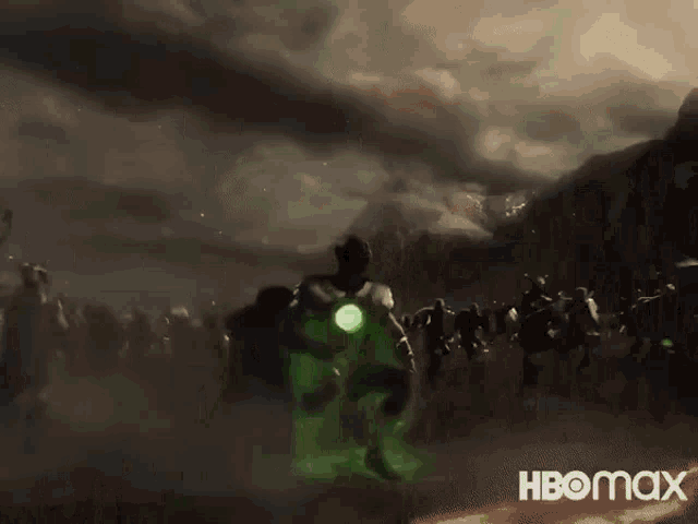a group of people are standing in front of a green glowing object .