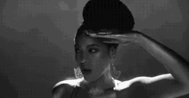 a black and white photo of a woman with a chef hat on her head .