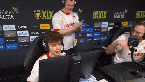 a group of people are sitting in front of a wall that says pro xix