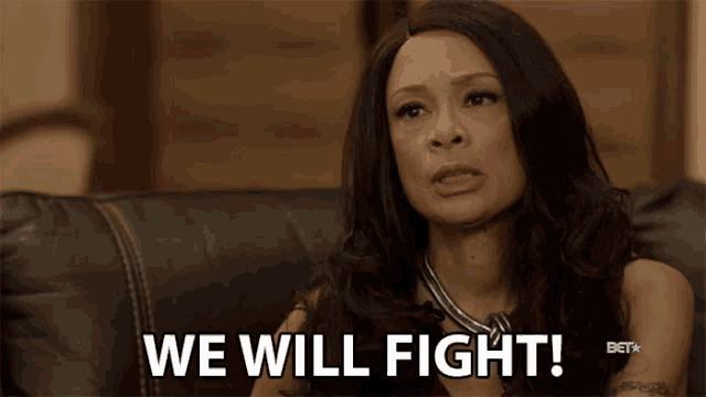 a woman sitting on a couch with the words we will fight