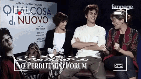 a group of people are sitting in front of a poster that says qualcosa di nuovo