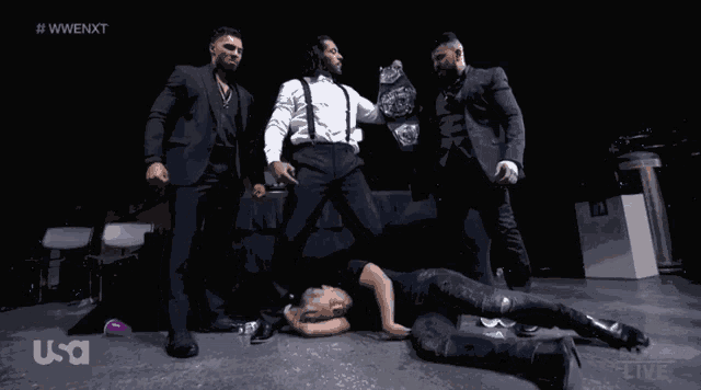 a group of men are posing for a photo with the hashtag #wwe nxt on the bottom