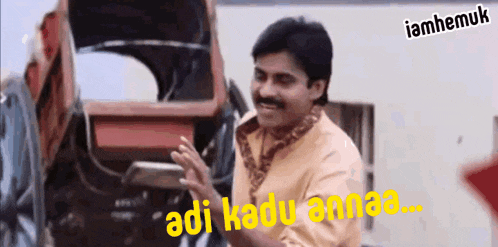 a man standing in front of a carriage with the words adi kadu anna written on the bottom