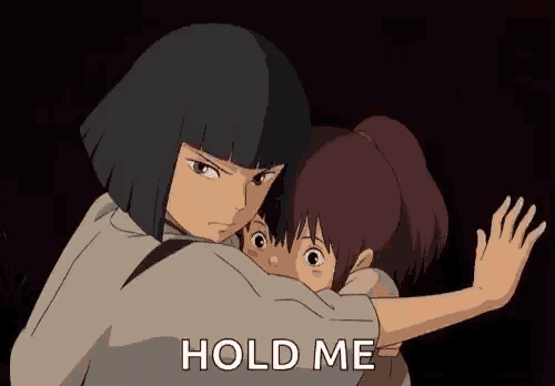 a man and a woman hugging each other with the words `` hold me '' .