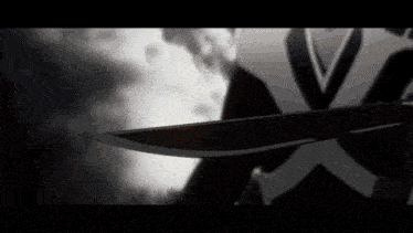 a close up of a person holding a knife in a dark room