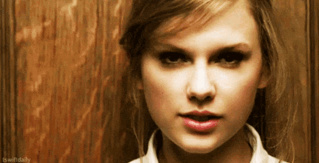 a close up of a woman 's face with the hashtag tswiftdaily