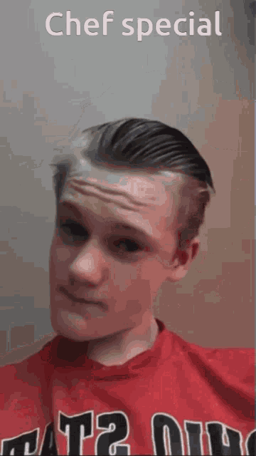 a young man wearing a red shirt that says chef special on it