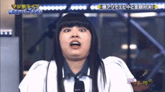 a woman making a funny face with chinese writing on the bottom
