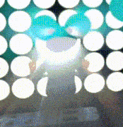 a person is standing in front of a wall of white dots
