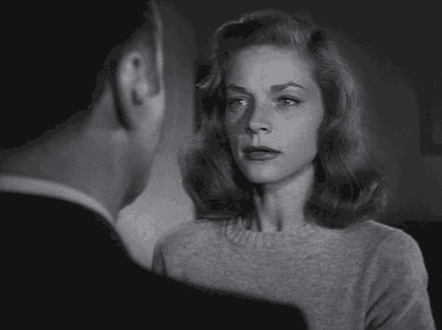 a black and white photo of a woman and a man