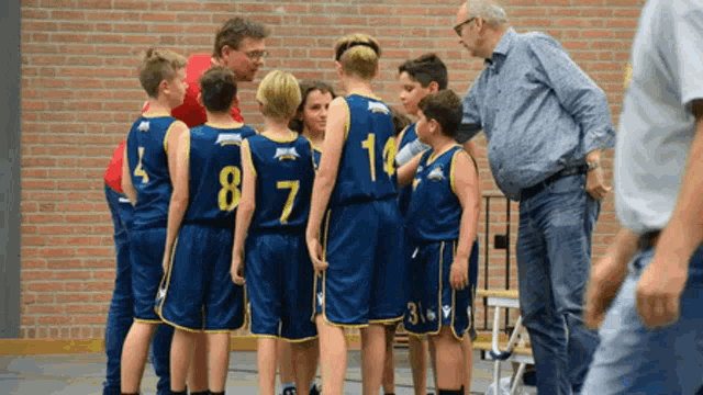 a group of young boys wearing blue jerseys with the numbers 8 7 and 14
