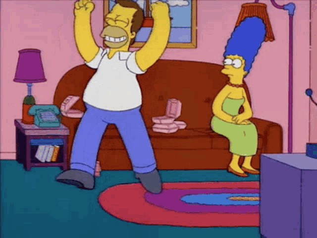 homer simpson is dancing in a living room while marge sits on a couch