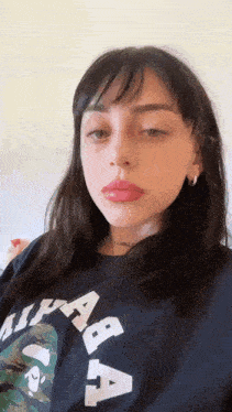 a close up of a woman wearing a black shirt
