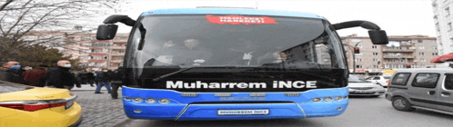 a blue bus with muharram ince written on the front