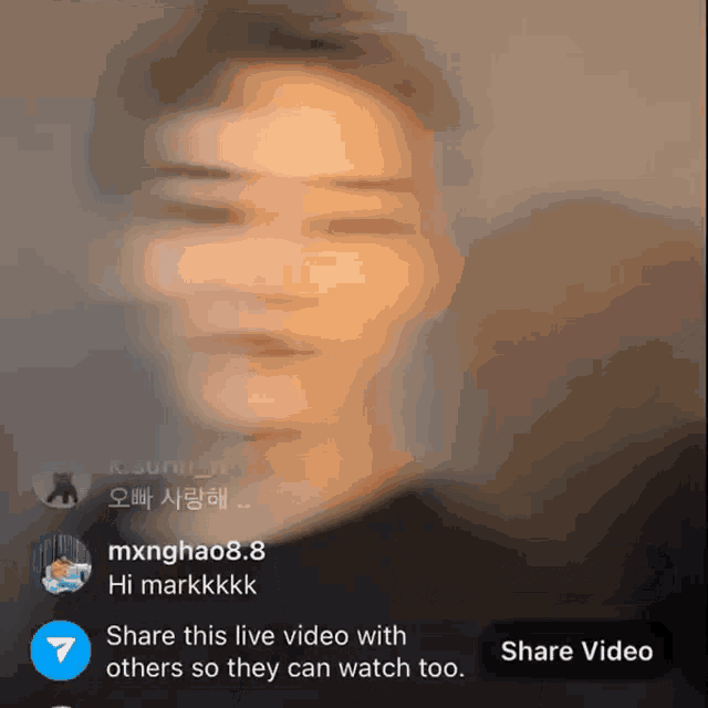 a blurred image of a person with a share video button below it
