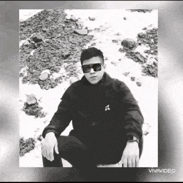 a black and white photo of a man wearing sunglasses and a jacket