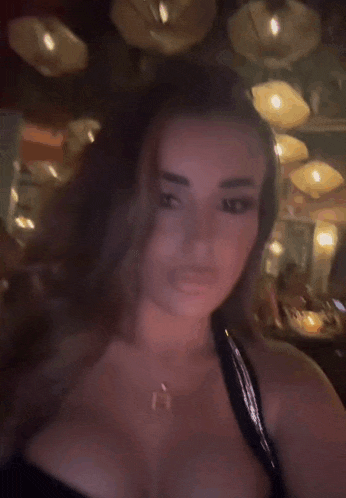 a woman is making a funny face with her lips .