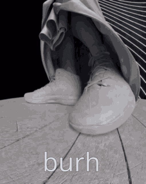 a black and white photo of a person 's feet with the word burh written on the bottom