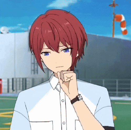 a boy with red hair and blue eyes is wearing a watch on his wrist