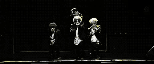 a group of people are dancing on a stage .