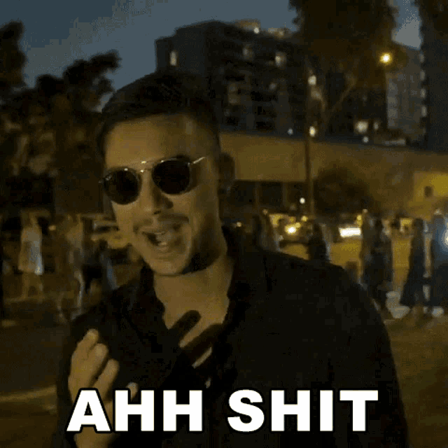 a man wearing sunglasses is making a funny face and says ahh shit