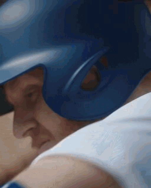 a baseball player is wearing a blue helmet