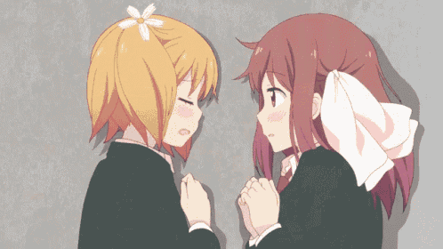 a girl with a flower in her hair is laying next to a girl with a flower in her hair