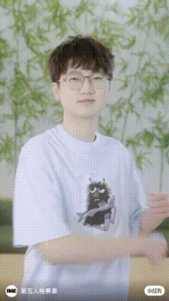 a man wearing glasses and a white t-shirt with a cat on it
