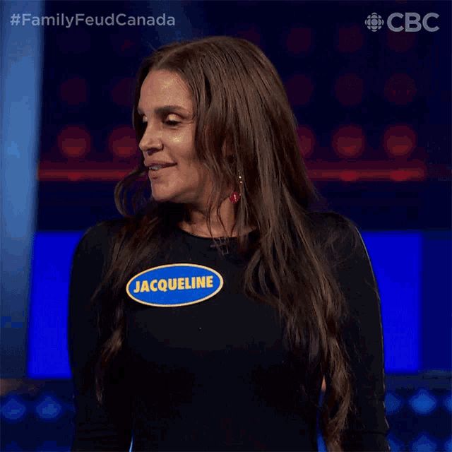 a woman wearing a black shirt with a name tag that says jacqueline