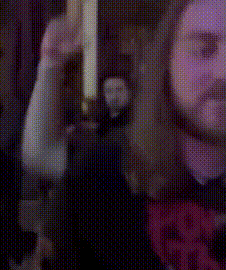 a blurry picture of a person 's face with a purple background .
