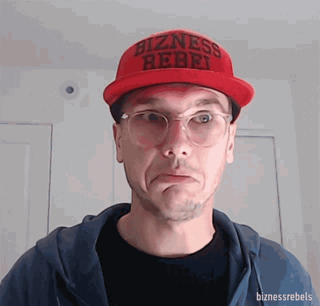 a man wearing a red hat that says " bizness rebel "