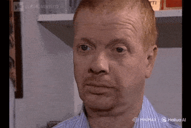 a close up of a man 's face with the words minimx on the bottom right corner