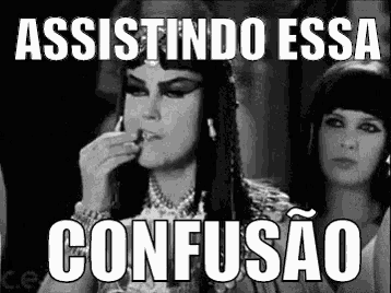 a black and white photo of a woman smoking a cigarette with the words `` assistindo essa confusao '' written on it .