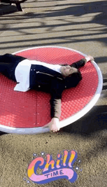 a woman is laying on a red circle with the words chill time on the ground