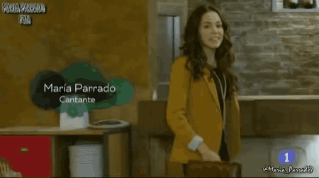 a woman in a yellow jacket stands in front of a sign that says maria parrado cantante on it