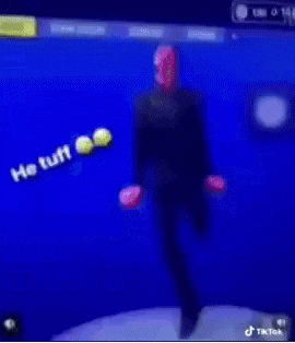 a blurry picture of a person playing a video game with the words he tuff written on the screen