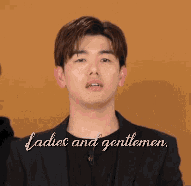 a man in a suit says ladies and gentlemen in white letters