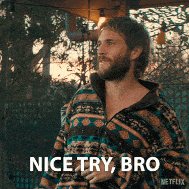 a man with a beard is wearing a colorful jacket and says nice try bro